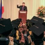man delivering speech on graduation